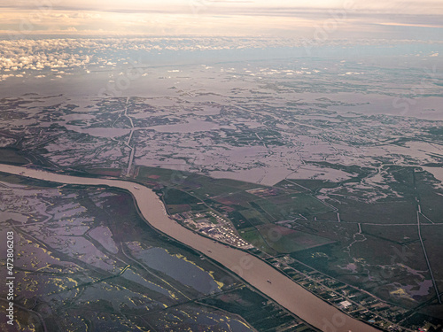 Mississippi winds through wetlands below New Orleans, Louisiana. Rising oceans threaten these wetlands, along with over channelizing the river with dikes along the river. photo