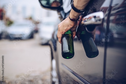 Drunk driver drinking alcohol in car and holding beer bottle © Daniel Jędzura