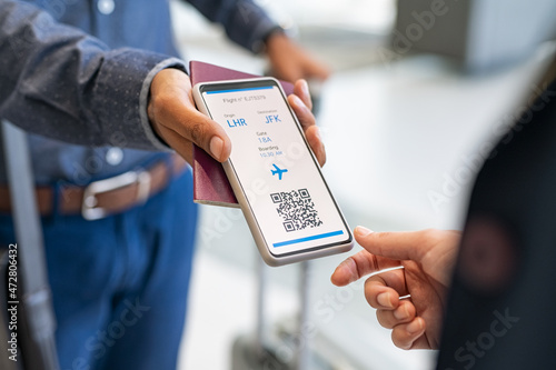 Man showing digital flight e-ticket to stewardess