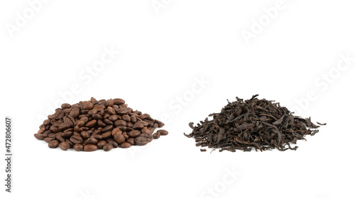 Heap of medium roasted coffee beans and dry black tea leaves isolated on white background.