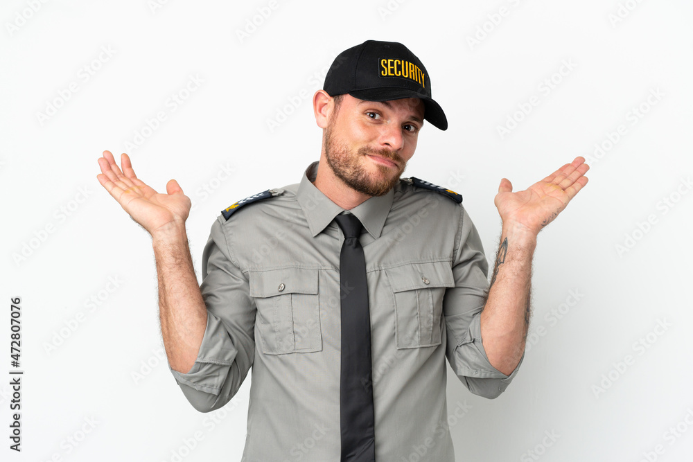 Young security Brazilian man isolated on white background having doubts while raising hands Young security Brazilian man isolated on white background having doubts while raising hands