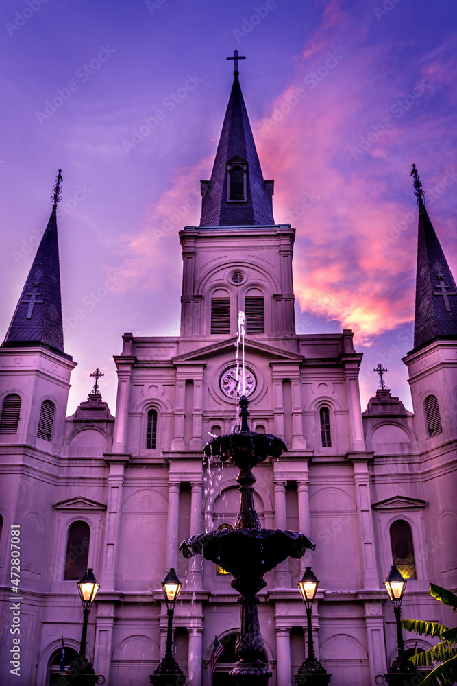 Fototapeta premium Sunset Fountain Saint Louis Basilica Cathedral Oldest Cathedral facade, New Orleans, Louisiana. Built 1718 King Louis France.