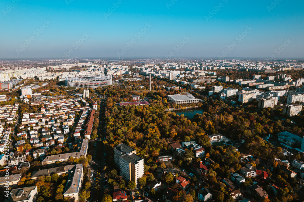 Obraz premium Aerial landscape of Bucharest, from the Vatra Luminoasa neighborhood with the National Arena stadium and blue sky in the background. The iconic architecture and landscape of Bucharest, Romania