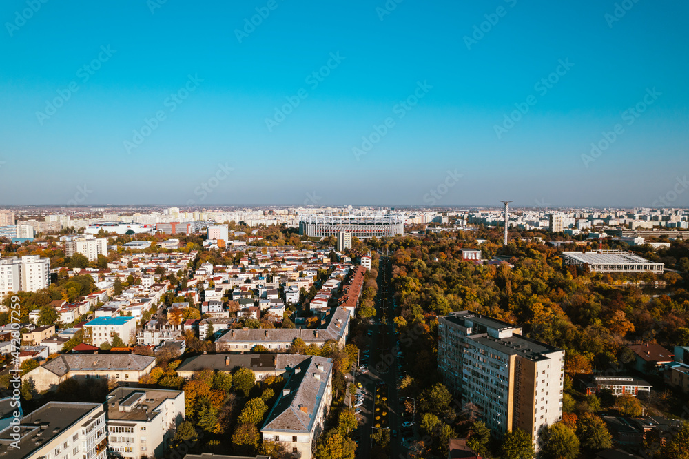 Aerial landscape of Bucharest, from the Vatra Luminoasa neighborhood with the National Arena stadium and blue sky in the background. The iconic architecture and landscape of Bucharest, Romania
