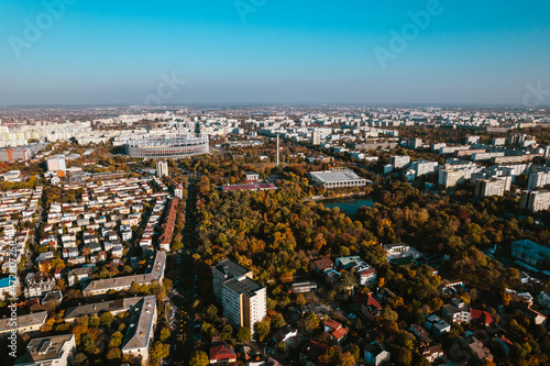 Aerial landscape of Bucharest, from the Vatra Luminoasa neighborhood with the National Arena stadium and blue sky in the background. The iconic architecture and landscape of Bucharest, Romania