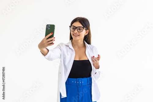 Fotografie Young woman taking selfie, sending kisses at mobile phone camera, romatnic video
