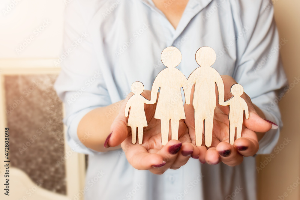 Female hands are holding a wooden figurine of a family. Selective focus. Family creation and planning concept. Family care - hands with a wooden silhouette.
Female hands are holding a wooden figurine of a family. Selective focus. Family creation and planning concept. Family care - hands with a wooden silhouette.