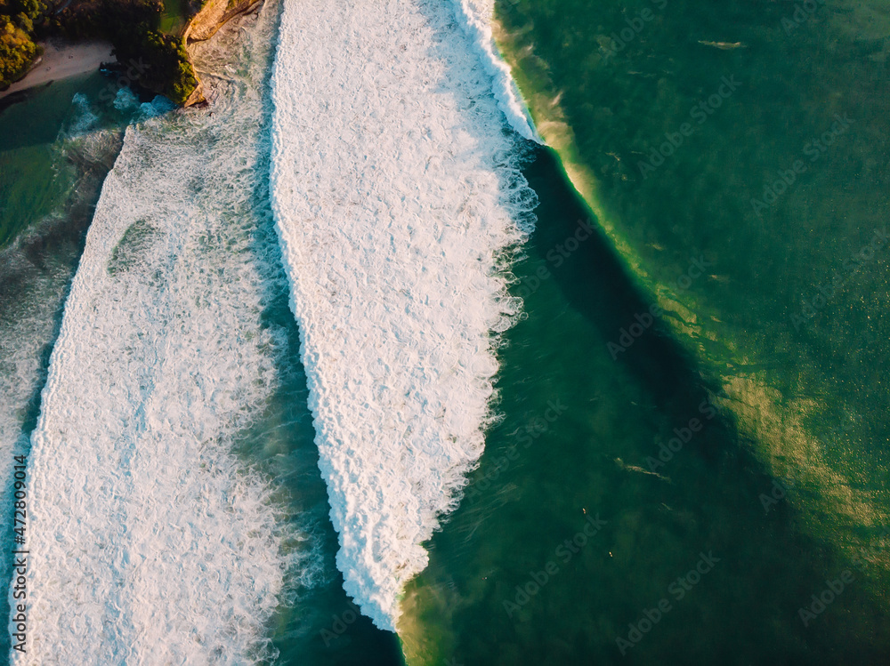 Aerial view of big stormy waves at sunset. Perfect swell for surfers