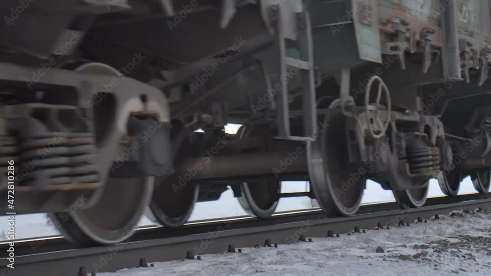 Close-up, Freight train wagons go on the railway in winter covered with snow. Northern railway railroad transportation Close-up, Freight train wagons go on the railway in winter covered with snow. Northern railway railroad transportation