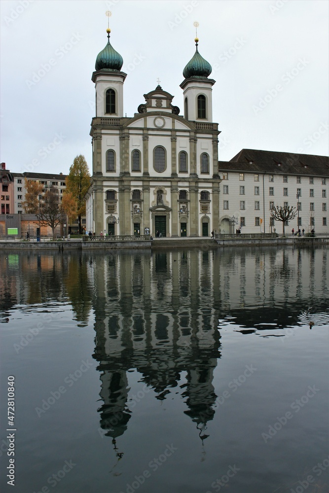 Jesuit Church, the first large Baroque church built in Switzerland north of the Alps, reflected in the River Reuss during winter (Lucerne, Switzerland)