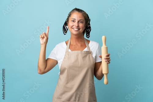Middle age woman in chef uniform pointing up a great idea