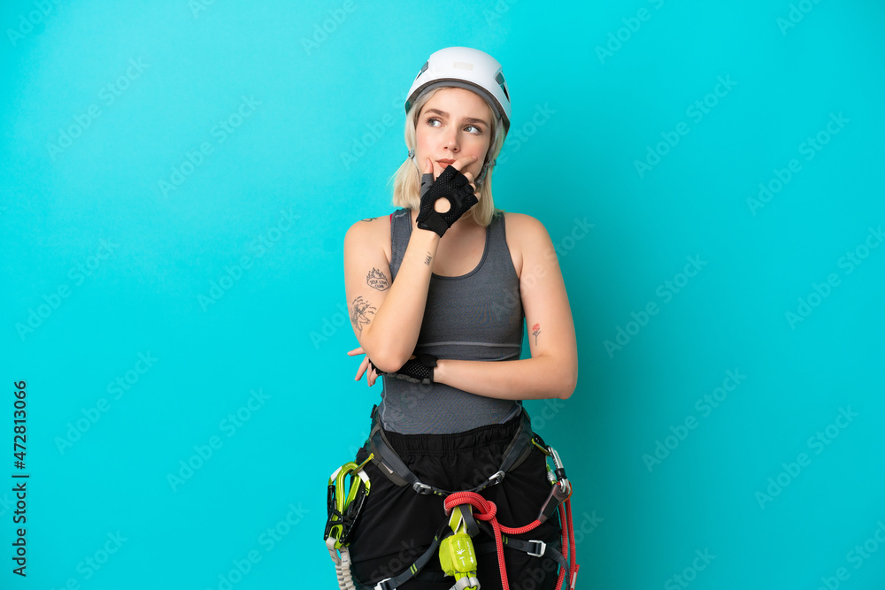 Young caucasian rock-climber woman isolated on white background having doubts and with confuse face expression Young caucasian rock-climber woman isolated on white background having doubts and with confuse face expression