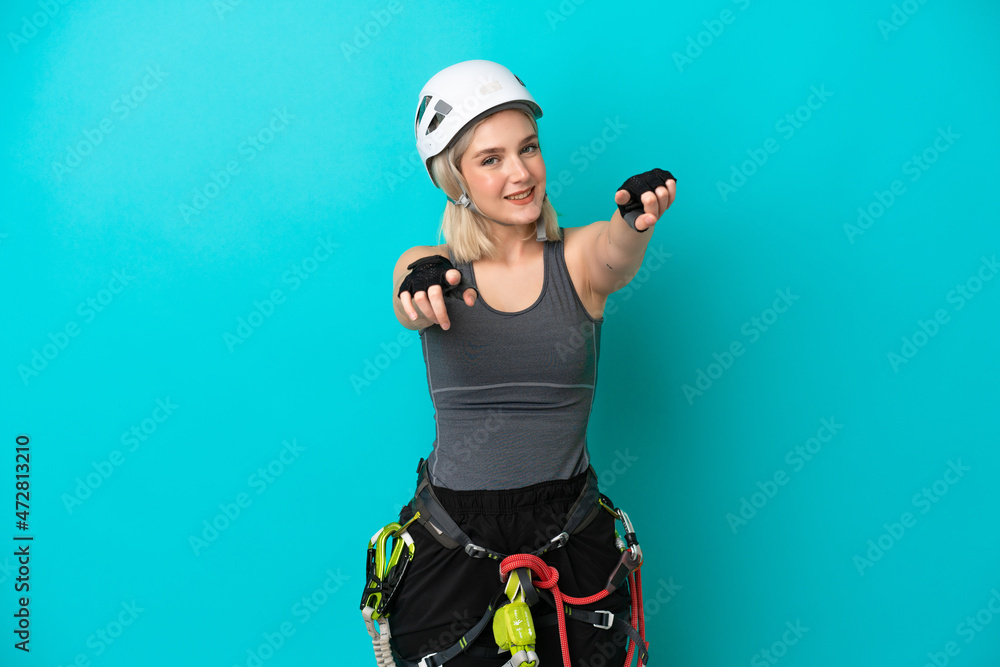 Young caucasian rock-climber woman isolated on white background points finger at you while smiling Young caucasian rock-climber woman isolated on white background points finger at you while smiling
