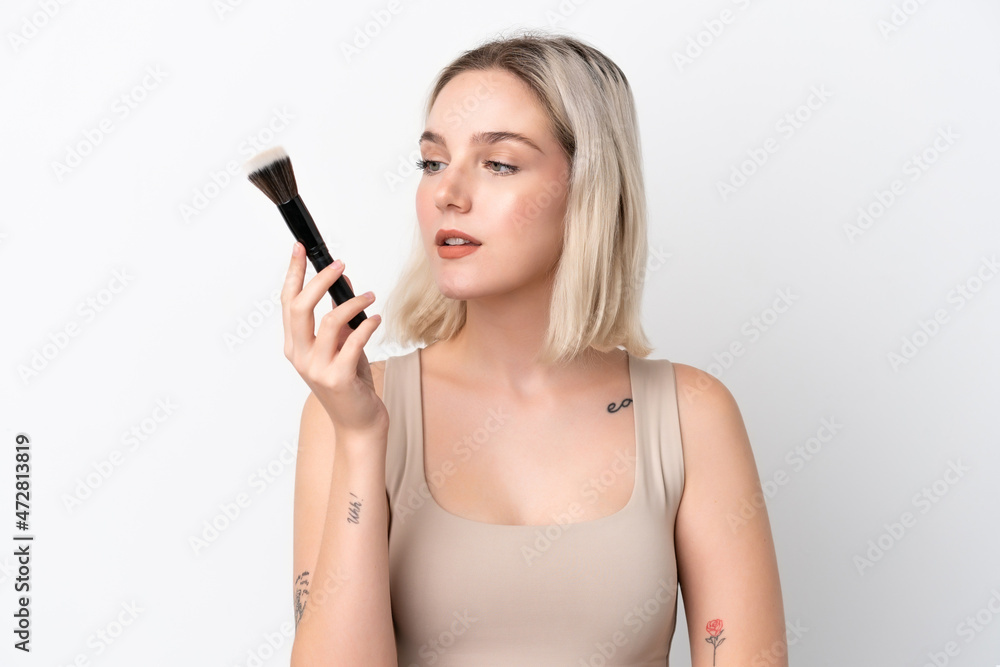 Young caucasian woman isolated on white background holding makeup brush Young caucasian woman isolated on white background holding makeup brush