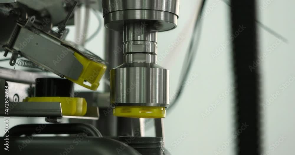 Machine oil production plant. Gray plastic bottles move along a conveyor line to fill and pack motor oil. Development, storage and supply of lubricants for industrial enterprises. RED camera. Machine oil production plant. Gray plastic bottles move along a conveyor line to fill and pack motor oil. Development, storage and supply of lubricants for industrial enterprises. RED camera.