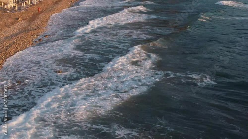 Waves smashing on the rocks during the golden hours, before the sunset, in Corfù, Greece. Filmed by drone photo