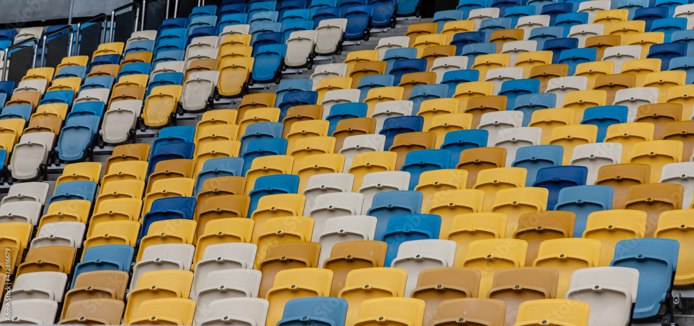 Fototapeta premium empty colorful seats on tribunes of stadium