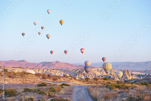 Travel and tourism by Turkey. Famous sightseeing Cappadocia, Anatolia. Beautiful landscape with mountains, caves and baloons in the sky.