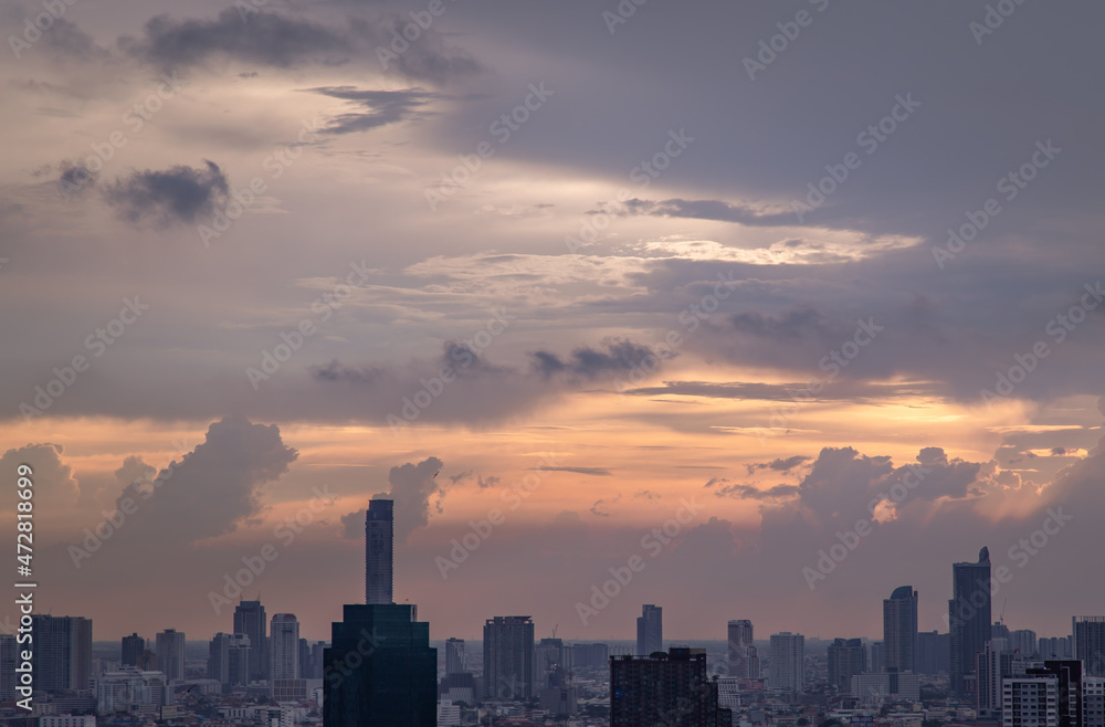 Fototapeta premium Bangkok, Thailand - Mey18, 2021 : Gorgeous panorama scenic of the sunrise or sunset with cloud on the orange and blue sky over large metropolitan city in Bangkok. Copy space, No focus, specifically.