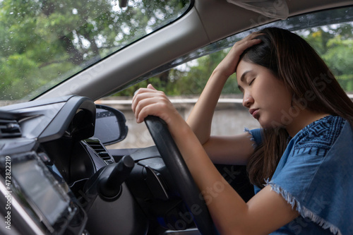 Stressed woman drive car feeling sad and angry. Asian girl tired, fatigue on car. Driver tired drowsy, drink don’t drive concept. Sleepy and drunk female hangover. Illegal law driver license.