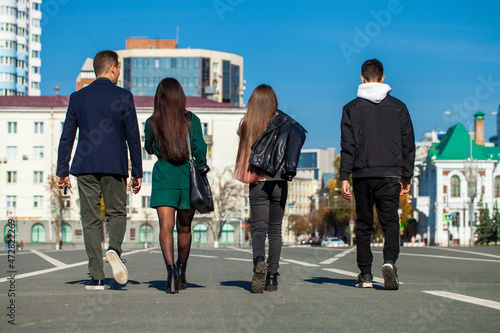 family walking along the autumn street