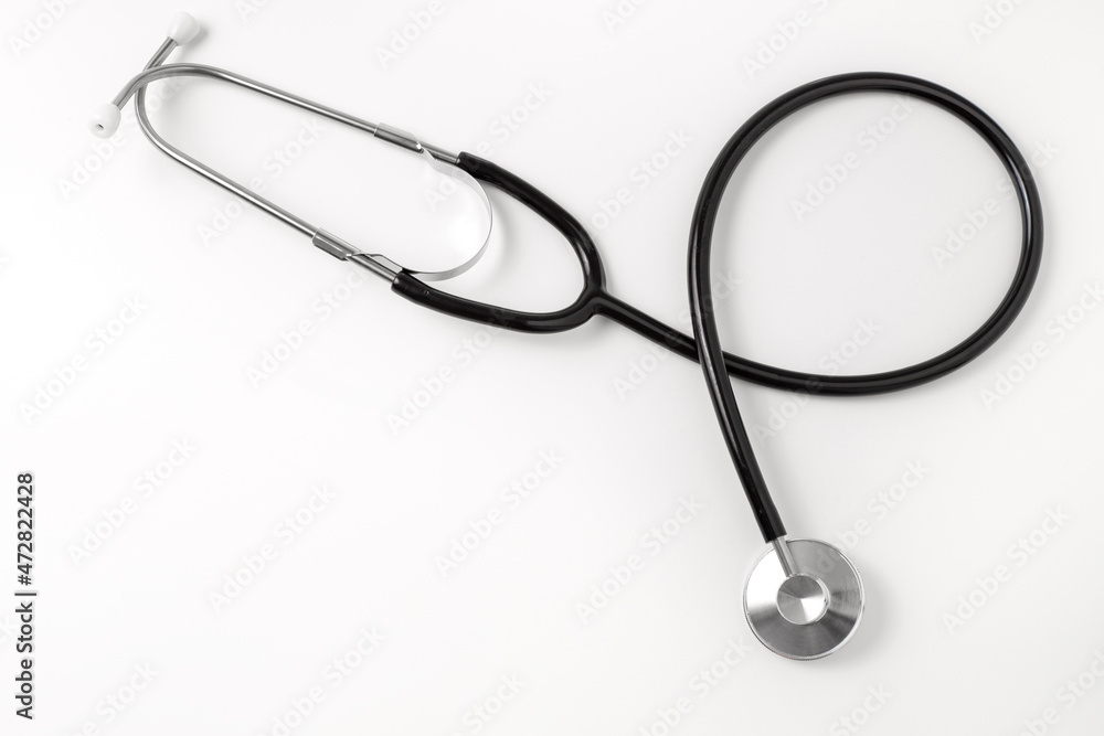 Stethoscope on white background, top view. Medical tool. Copy space, free space for text. Stethoscope on white background, top view. Medical tool. Copy space, free space for text.