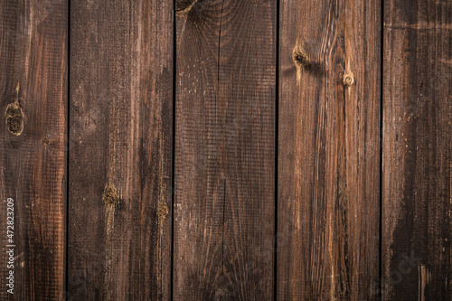 The background is made of brown old boards. Brown wooden background