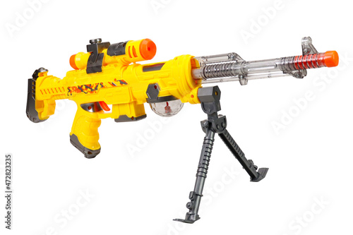 Yellow toy submachine gun on a white background. Isolated image