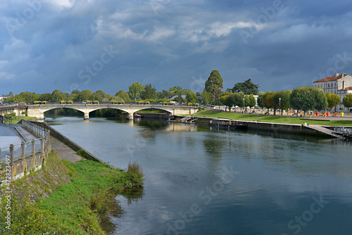 River Charente and bridge at Saintes, a commune and historic town in western France, in the Charente-Maritime department of which it is a sub-prefecture, in Nouvelle-Aquitaine  photo