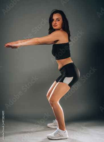 Attractive fitness woman preforming stretching exercise