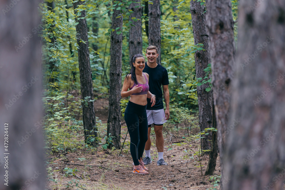 Fit male and female athletes running in nature. Nature and sports concept. Fit male and female athletes running in nature. Nature and sports concept.