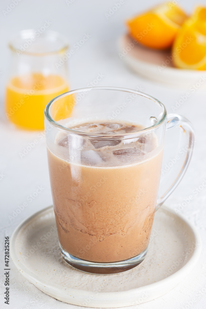 Cold vegan moccacino coffee with chocolate and orange juice in a glass mug. Cold vegan moccacino coffee with chocolate and orange juice in a glass mug.