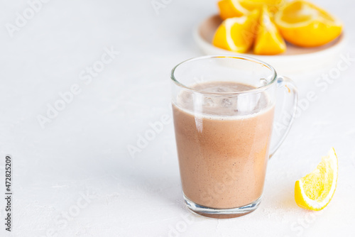 Mocha coffee with chocolate and orange juice in a glass mug. Horizontal orientation, copy space.