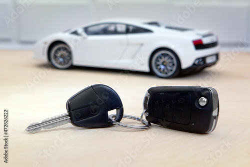 Credit car concept. Toy supercar in blurred background.