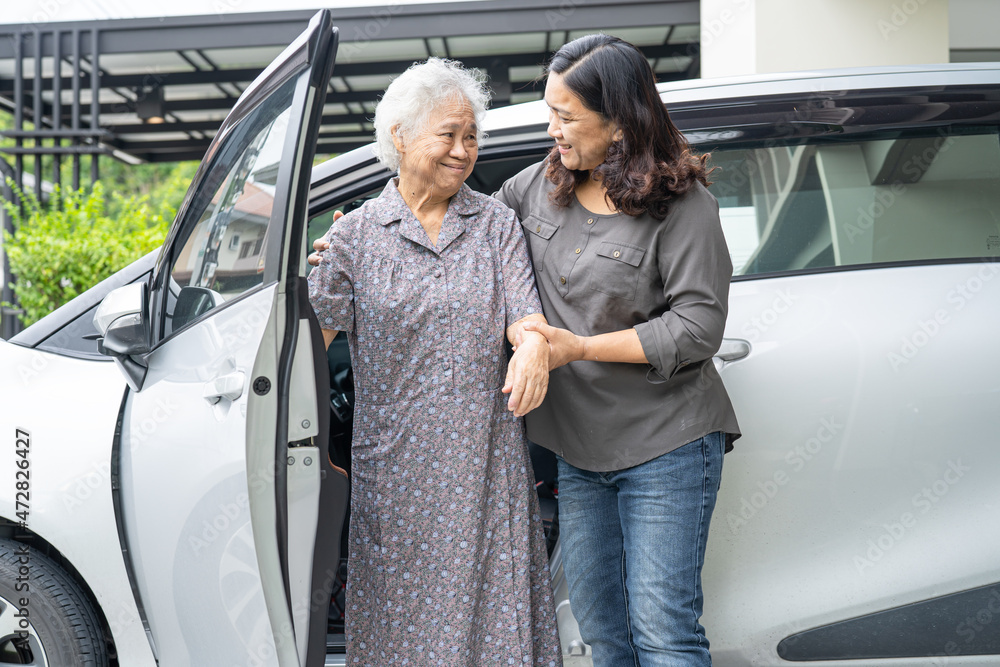 Help and support asian senior or elderly old lady woman patient sitting on wheelchair prepare get to her car, healthy strong medical concept. Help and support asian senior or elderly old lady woman patient sitting on wheelchair prepare get to her car, healthy strong medical concept.