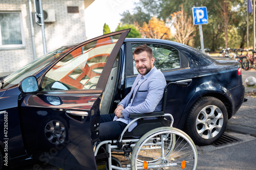 Handicapped young man reaching for his car © didesign