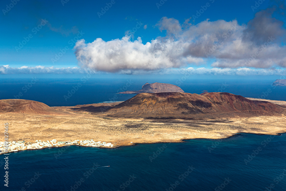 Unique nature and beautiful colorful beaches of volcanic Lanzarote. View of La Graciosa island. Canary islands