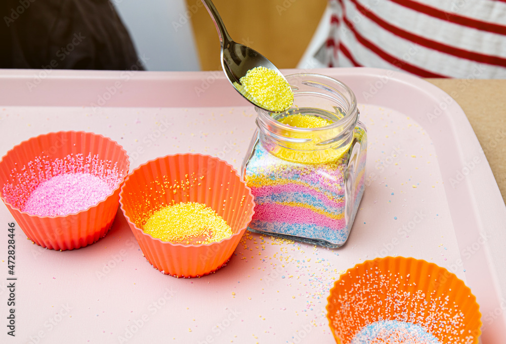 Young children making fun colorful layered granulated wax candles