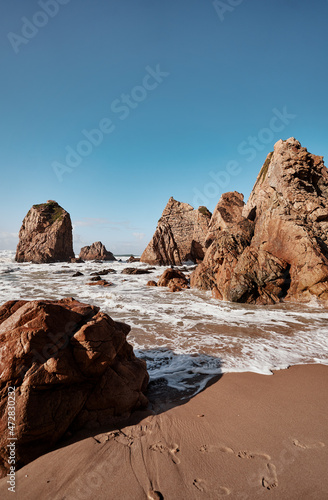 Cliffs and rocks on the Atlantic ocean coast - Praia da Ursa beach, Portugal.