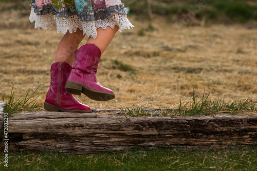A Young Girl Kid Child in Cowboy Boots Balancing on A Railroad Tie Balance Skirt Dress Girly Childhood Unplugged Get Outside Fresh Air Fun 
