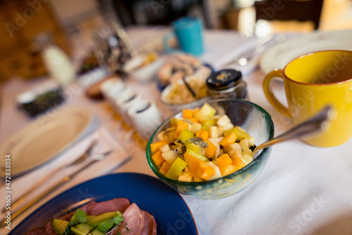 Well laid table with organic homemade food and treats for sunday brunch in living room at home photo