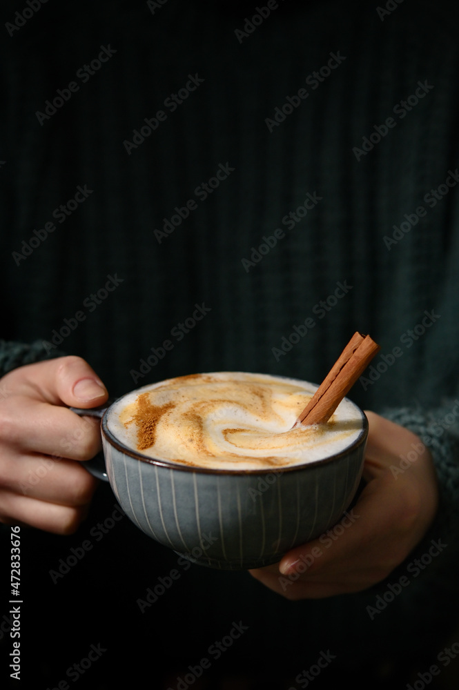 Woman holding Cup of cappuccino