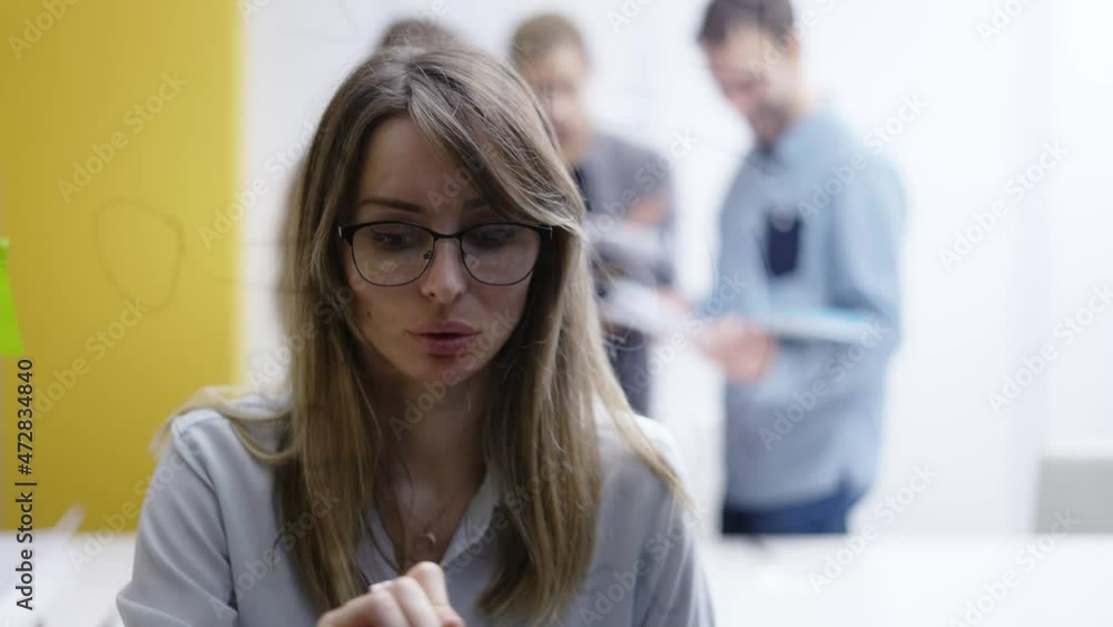 Woman leader on corporate training using glass wall to wite strategy, front view Woman leader on corporate training using glass wall to wite strategy, front view