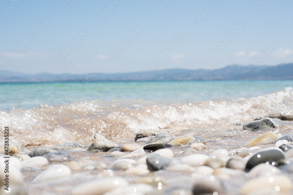 Ripple water of sea on pebble shore in summer day Ripple water of sea on pebble shore in summer day