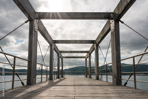 Empty wooden pier over river photo