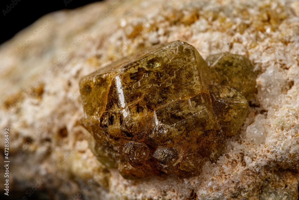Macro stone Grossular mineral on a black background Macro stone Grossular mineral on a black background