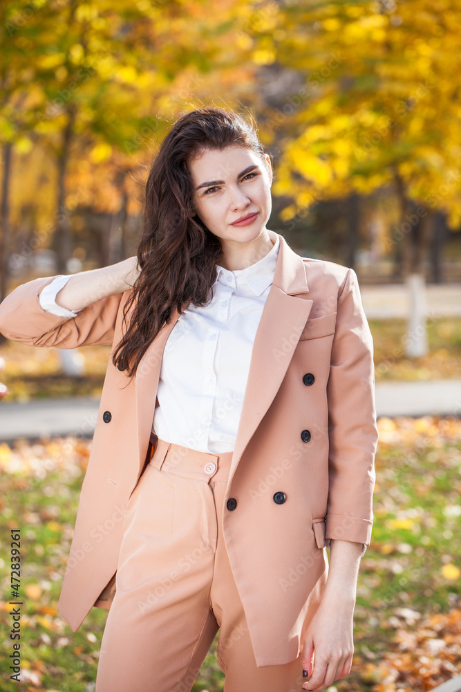 Portrait of a young beautiful brunette woman in autumn park Portrait of a young beautiful brunette woman in autumn park