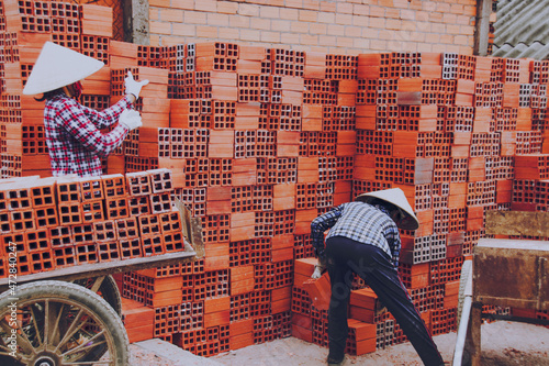 Workers in the traditional brick-making village along the banks of the Co Chien River in Vinh Long Province, Vietnam