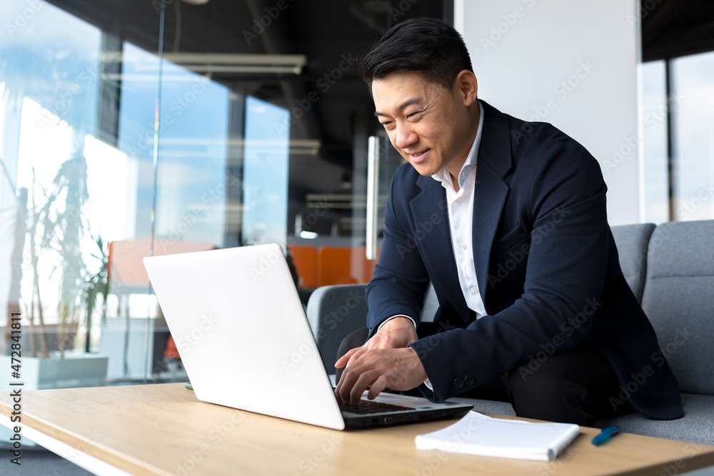 Successful and happy asian man working online remotely on laptop smiling happy with plan and task Successful and happy asian man working online remotely on laptop smiling happy with plan and task