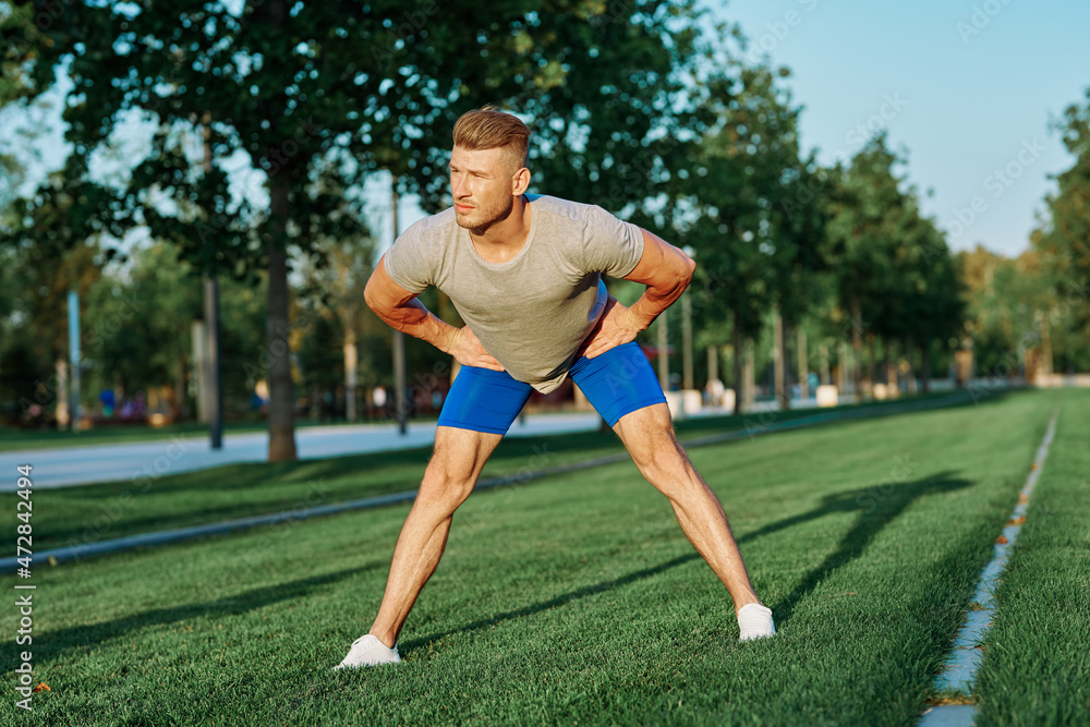 sporty man in the park on the lawn exercise lifestyle